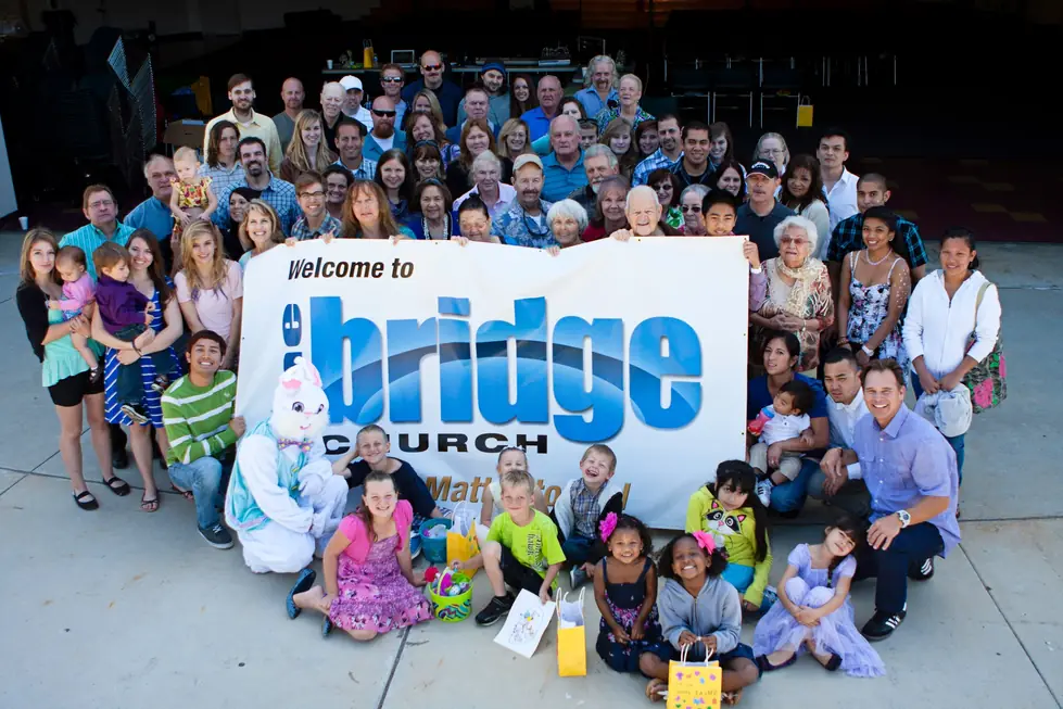 The Bridge Church family gathered outside around the Welcome to the bridge church banner at Easter