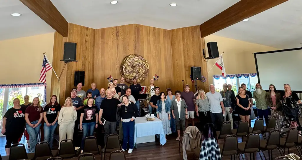 The Bridge Church family standing together in the cedar-panelled Casitas Del Sol Clubhouse hall